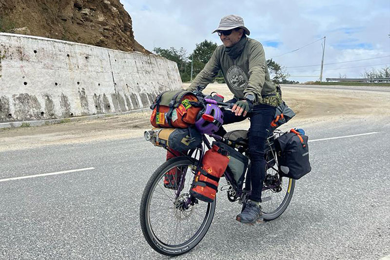 Dhruv riding fully loaded bike on mountain road