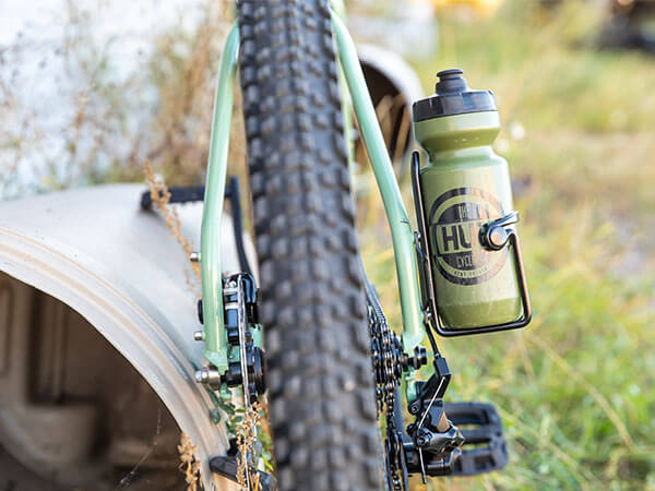 View from rear of Grappler bike with seatstay water bottle mounted on drive-side