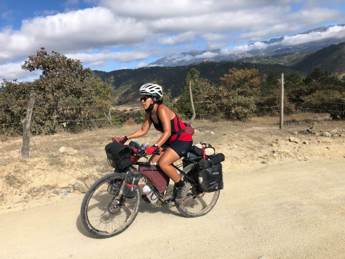 Andrea riding with mountains behind her