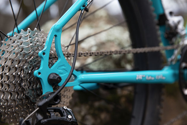 Zoom in of the back wheel hub area of a Surly Bridge Club bike, with a focus view of the cassette and rear derailleur 