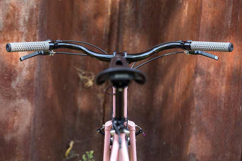 View from back of the bike looking at saddle to crusier handlebars with gray colored grips