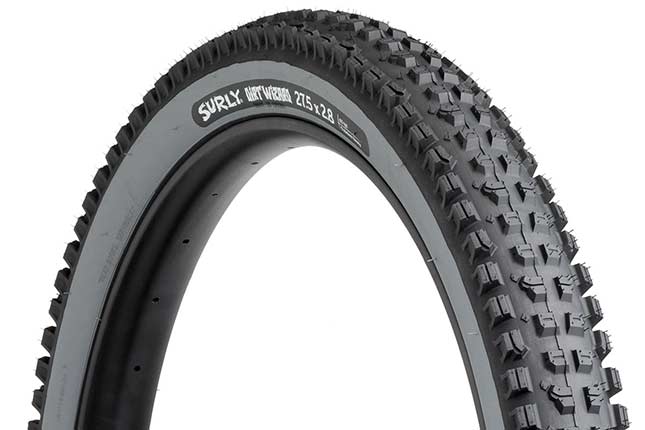 Surly Dirt Wizard 27.5 x 2.8 inch tire with slate gray sidewall showing tread with hot patch on white background