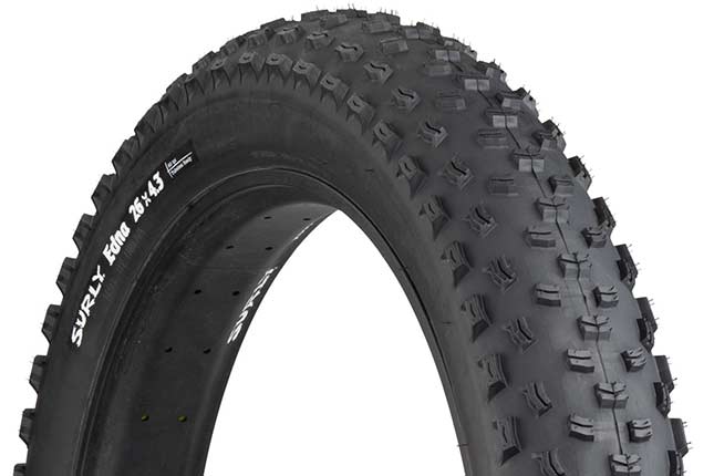 Surly Edna 26 x 4.3 inch fat bike tire mounted on rim showing tread and sidewall with white hot patch on white background