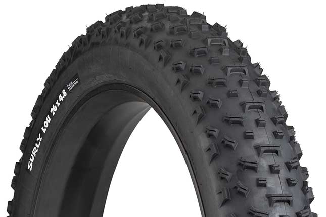 Surly Lou 26 x 4.8 inch fat bike tire mounted on rim showing tread and sidewall with white hot patch on white background