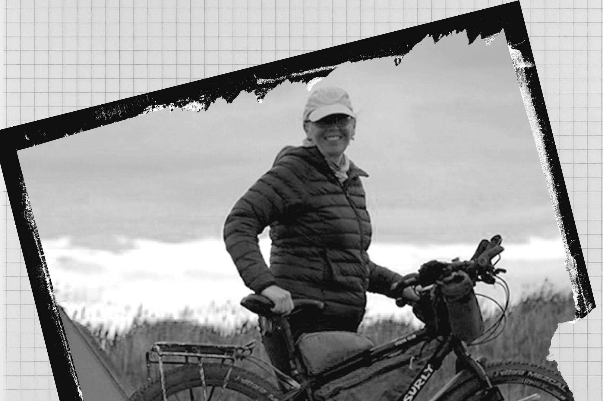 Monica standing with Surly Bridge Club bike wearing bike helmet